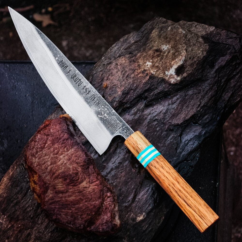 VALKYRIE III Damascus chef's knife with a long blade and a wooden handle with blue bands.