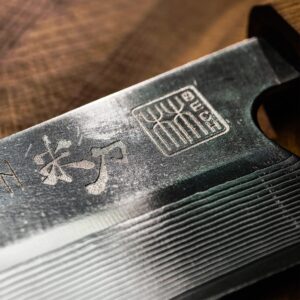 VALKYRIE III blade close-up with brand marks, Chinese characters and fine parallel lines.
