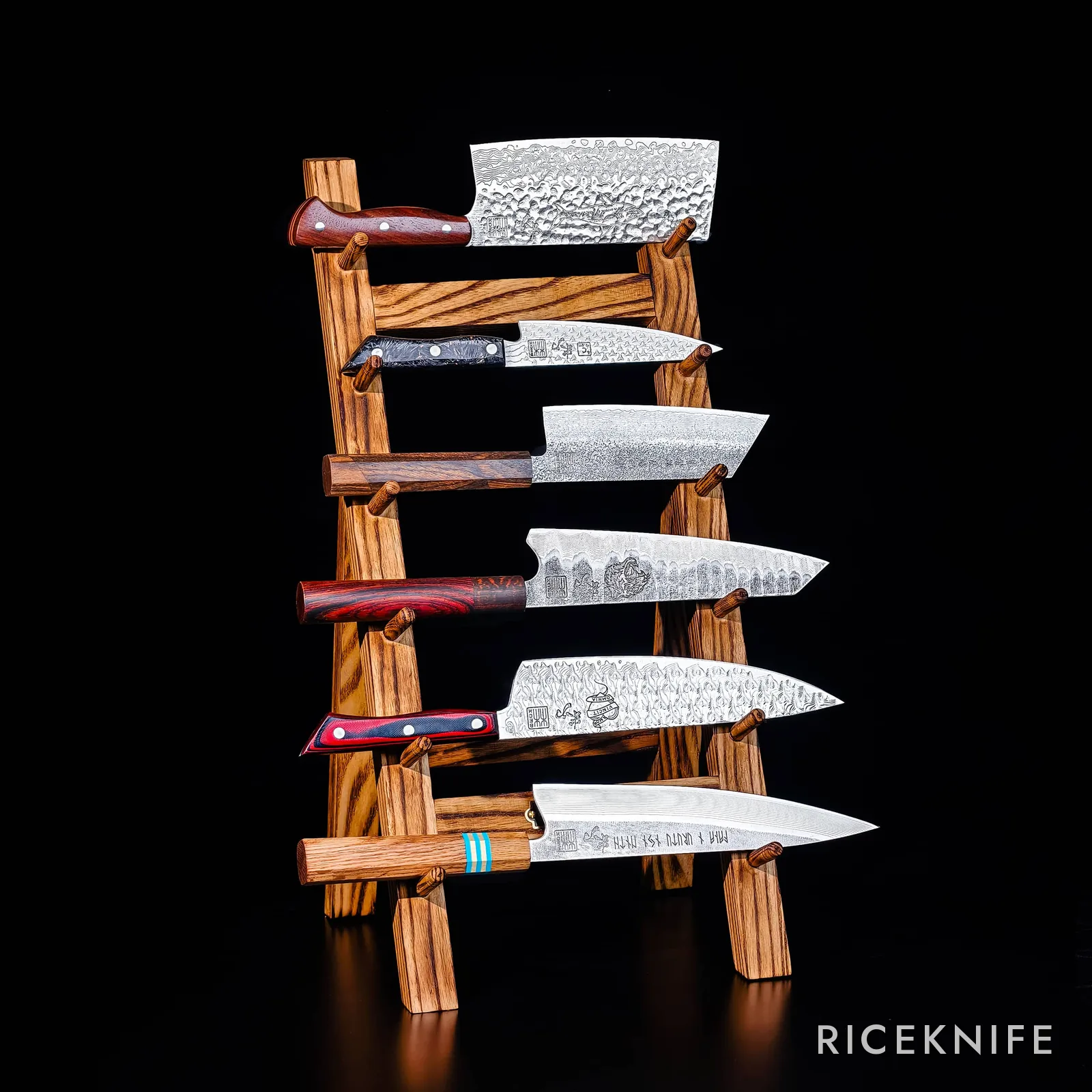 The six EX-ANIMO III Damascus knives on a wooden stand