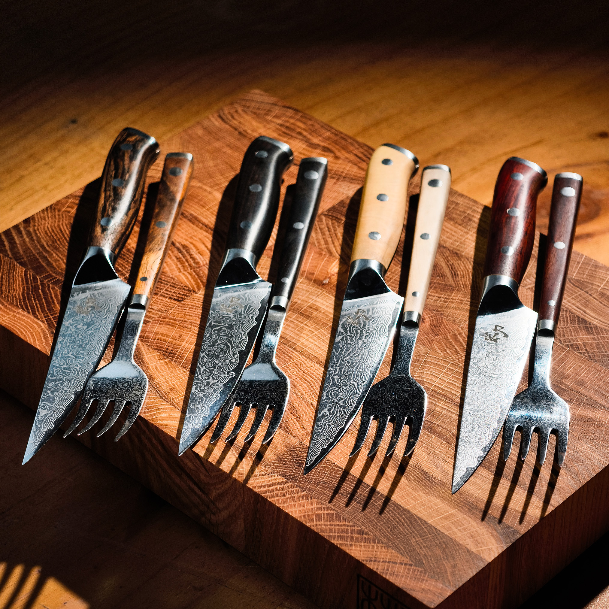 Luxurious exclusive Damascus steel steak knives and forks with Bocote, European Boxwood, Cocobolo and Ebony handles