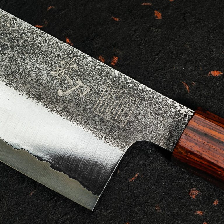 Heel of the blade with its marks, ash-dark area above lighter steel