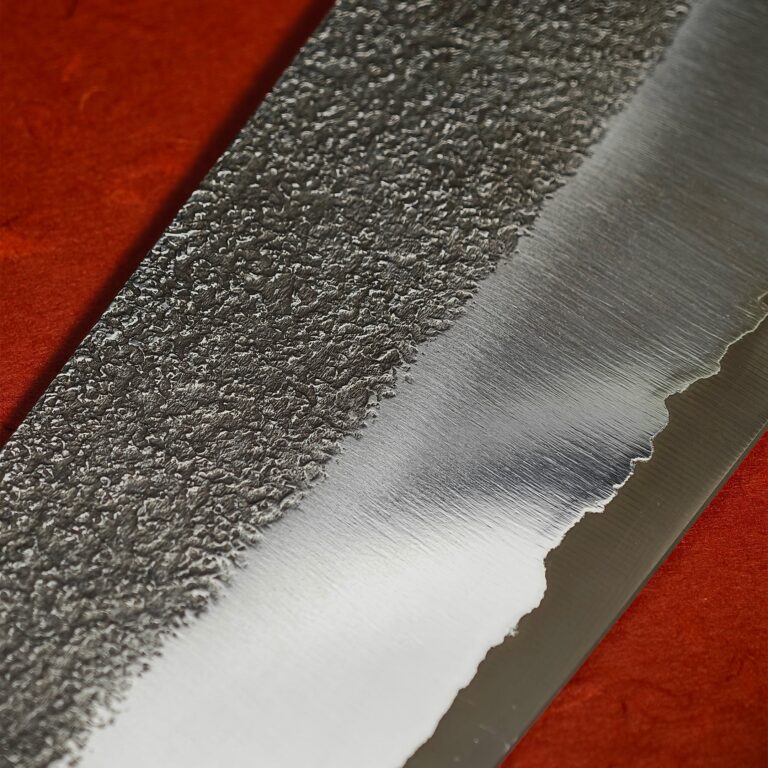Close view where the ash-dark area meets the lighter steel