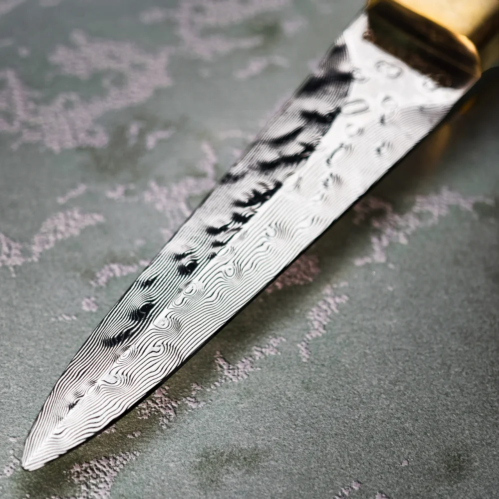 Close-up of the Damascus blade of the RICEKNIFE ebony oyster knife